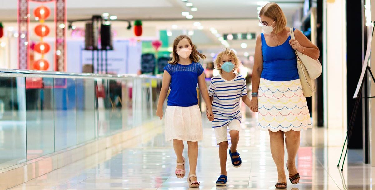 A family on a trip to the mall wearing face masks.